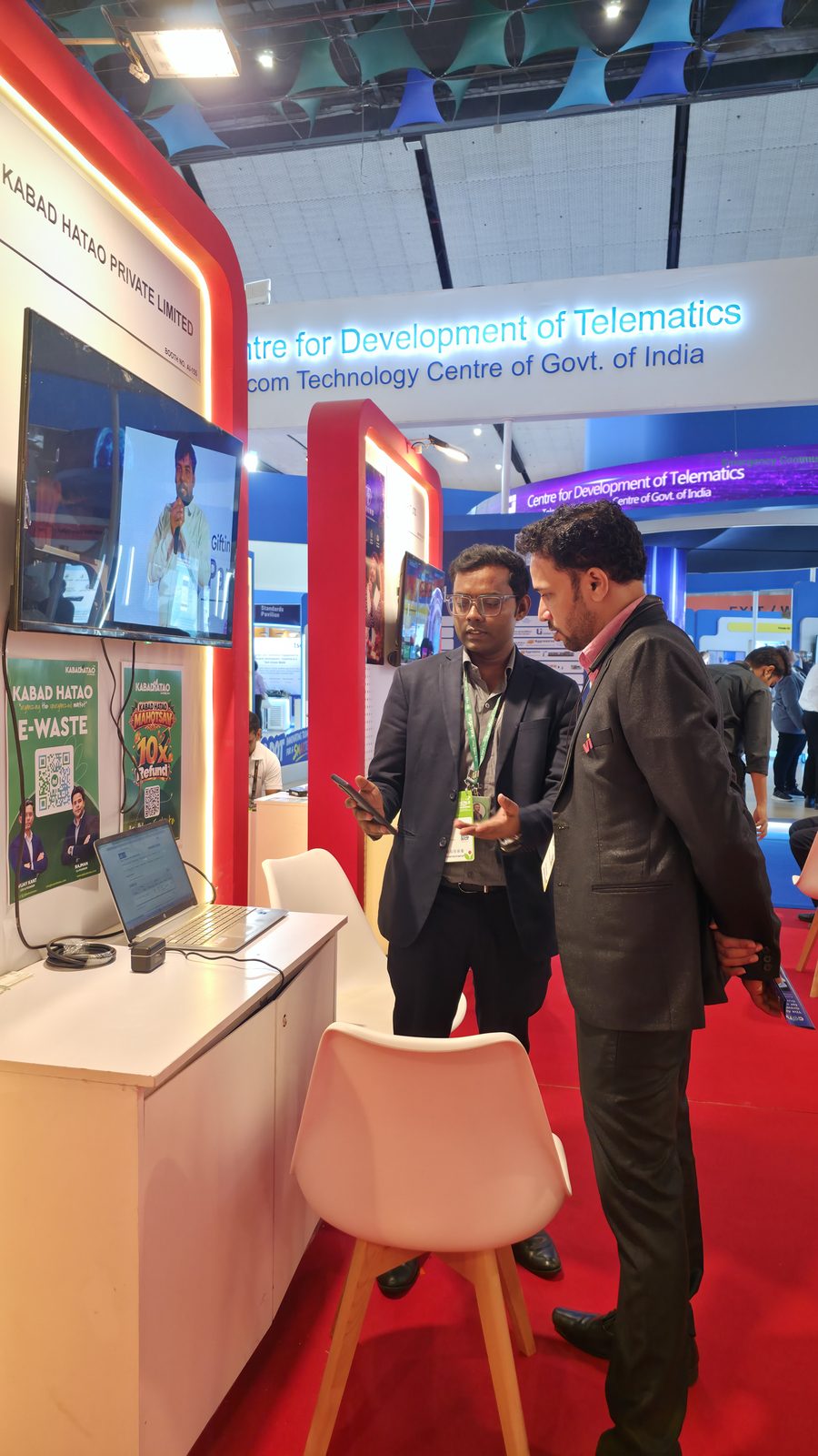A visitor speaking with the Kabad Hatao team at the stall.
