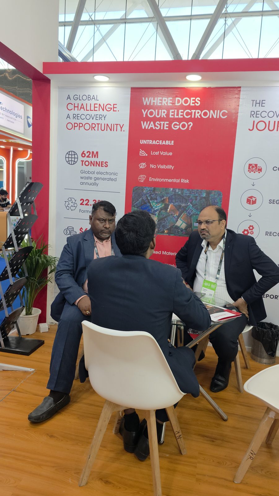 Discussion on electronic waste at an IMC stall.