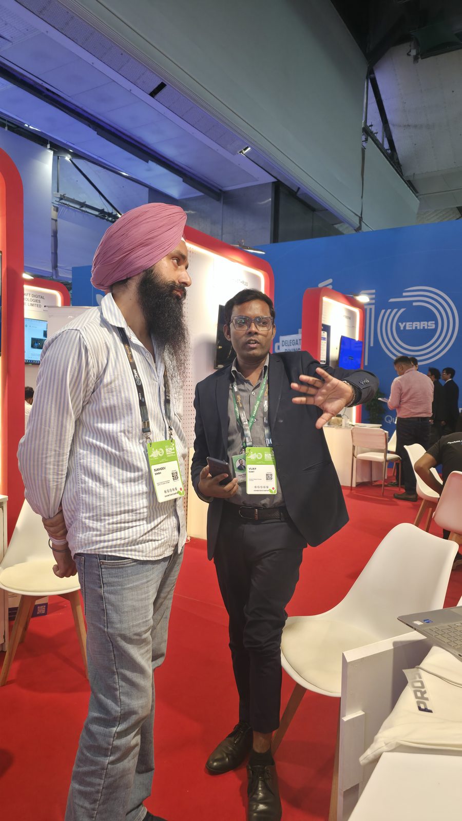 Team member talking with a visitor on the IMC floor.