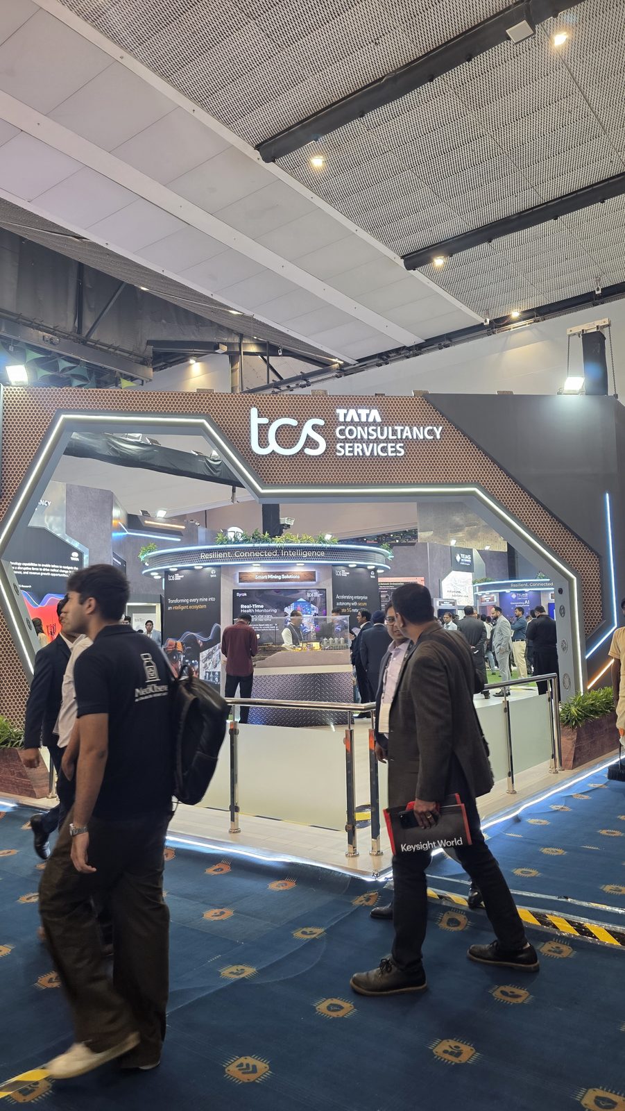 Visitors passing stalls on the IMC floor.