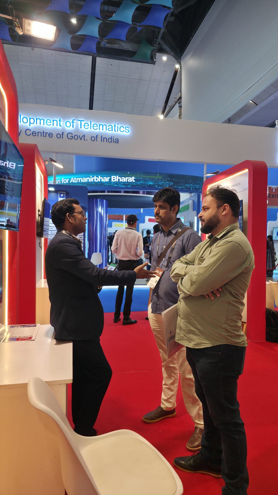 Team members speaking with a visitor.