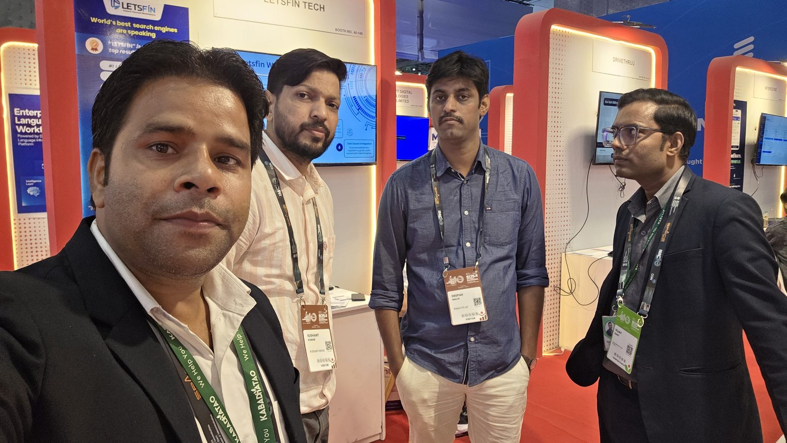 Team selfie with visitors at the booth.