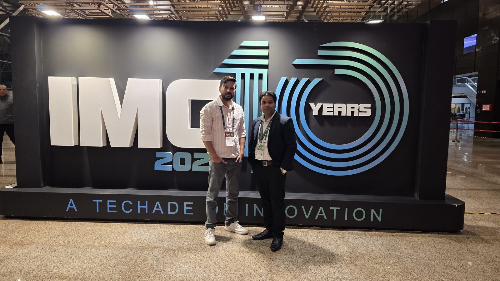 Two teammates in front of IMC 10 Years.